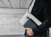 A5 navy blue memobottle being carried with a laptop