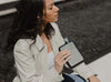 Woman holding A6 black stainless steel memobottle